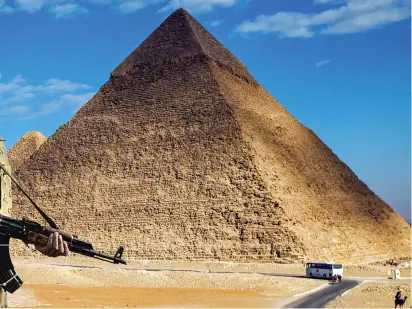  ??  ?? Gun guard: Egypt has high security at its prime tourist resorts and at the Pyramids