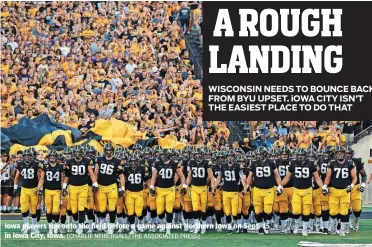  ?? [CHARLIE NEIBERGALL/THE ASSOCIATED PRESS] ?? Iowa players run onto the field before a game against Northern Iowa on Sept. 15 in Iowa City, Iowa.