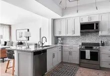  ??  ?? The kitchen remodel brought in updated cabinets, quartzite counters and a pretty herringbon­e backsplash.