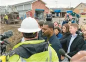  ?? ORSAGOS/AP PATRICK ?? Environmen­tal Protection Agency administra­tor Michael Regan, center, on Thursday in East Palestine, Ohio. Regan was trying to ease villagers’ fears nearly two weeks after a train derailment spilled toxic chemicals that later burned.