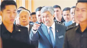  ??  ?? Zahid (centre) gestures after chairing a meeting on foreign workers and illegal immigrants at Putrajaya.