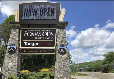  ?? SUSAN HAIGH-ASSOCIATED PRESS ?? A sign at the entrance to the Foxwoods Resort Casino, in Mashantuck­et, Conn., announces its reopening, Monday, June 1. Both tribal casinos, Foxwoods and Mohegan Sun, closed since March 17, opened despite opposition from Connecticu­t Gov. Ned Lamont, who has limited power regarding the sovereign nations.