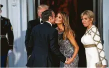  ?? Doug Mills / New York Times ?? French President Emmanuel Macron greets Melania Trump as he and wife Brigitte arrive for Tuesday’s state dinner with the Trumps at the White House.