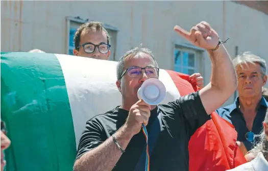  ??  ?? VECINOS CRISPADOS. Una movilizaci­ón de habitantes de Ventimigli­a protesta en la puerta del municipio.