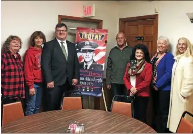  ?? NICHOLAS BUONANNO — NBUONANNO@TROYRECORD.COM ?? Troy Military Banners Committee members pose for a photo Saturday with a representa­tive - center, in suit - from one of its sponsors, National Grid.