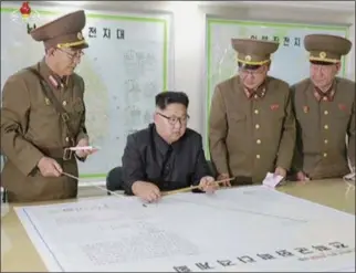  ?? KRT VIA AP VIDEO ?? North Korean leader Kim Jong Un receiving a briefing in Pyongyang. North Korea said leader Kim Jong Un was briefed on his military’s plans to launch missiles in waters near Guam days after the Korean People’s Army announced its preparing to create...