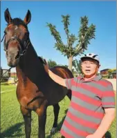  ??  ?? Fan Jiayi with a German warm blood at his farm. He plans to crossbreed the Bohai horse with German warm bloods.