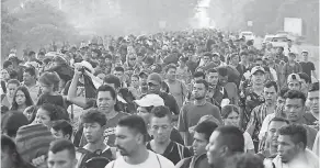  ?? MOISES CASTILLO/AP ?? Central American migrants walking to the U.S. depart Ciudad Hidalgo, Mexico, on Sunday as they make their way north.