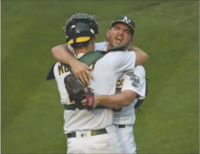  ?? JOSE CARLOS FAJARDO — BAY AREA NEWS GROUP ?? A’s pitcher Liam Hendriks celebrates with catcher Sean Murphy after striking out the White Sox’s Nomar Mazara for the final out of Game 3 of their American League wild-card series on Thursday in Oakland.