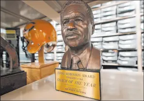  ?? John Bazemore The Associated Press ?? An Eddie Robinson Coach of the Year trophy is displayed at the College Football Hall of Fame in Atlanta. Robinson won 408 games at Grambling.