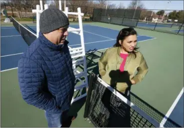  ?? STEVE HELBER — THE ASSOCIATED PRESS ?? David Harris Jr., left, the nephew of Arthur Ashe, and Richmond City Council member, Kim Gray, right, look over tennis courts where tennis star Arthur was banned on the Boulevard in Richmond, Va. The duo are attempting to get the Boulevard renamed for Ashe.