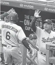  ?? CHARLES LECLAIRE / USA TODAY SPORTS ?? Dodgers outfielder Curtis Granderson celebrates his solo home run with manager Dave Roberts on Thursday.