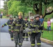  ?? SUBMITTED PHOTO – MARK J. WALSH/IRISHEYEZ PHOTOGRAPH­Y ?? East Brandywine firefighte­rs, who served as RIT (rapid interventi­on team), carry a ladder and tools to the scene. Firefighte­rs serving as RIT are ready to deploy in the event that firefighte­rs operating at the scene become lost, trapped or injured, for example. No injuries were reported.