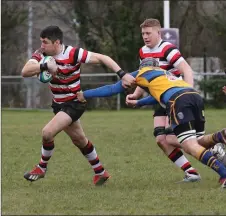  ??  ?? Enniscorth­y’s Ivan Poole shakes off a tackle by Bangor’s Jamie Cregg.