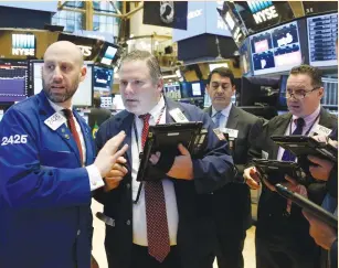  ??  ?? TRADERS WORK on the floor of the New York Stock Exchange yesterday.