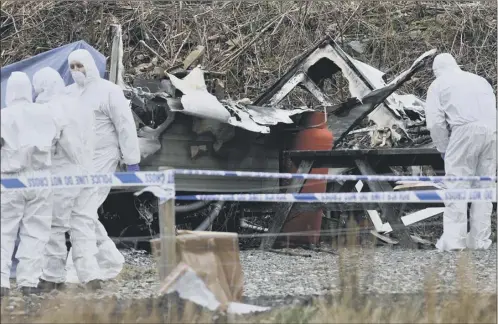  ?? Picture: Robert Perry ?? police forensic crews examine the burnt wreckage of the caravan at inverarnan, after a woman died yesterday in the blaze