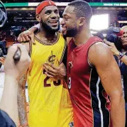  ?? [AP PHOTO] ?? Dwyane Wade and Lebron James meet after a 2015 game in Miami. Wade made it official and signed with Cleveland on Wednesday, rejoining his former teammate.