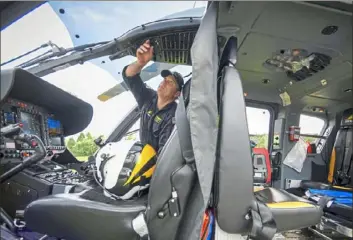  ?? Steve Mellon/Post-Gazette ?? Pilot Scott Jackson, of Leet, prepares a STAT MedEvac helicopter before taking off Aug. 22 in Cranberry. He’s part of a critical care transport team serving Western Pennsylvan­ia. “We’re here 24-7, 365,” Mr. Jackson says.