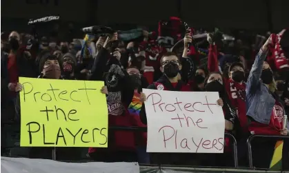  ?? Photograph: Steve Dipaola/AP ?? Portland Thorns fans hold signs in solidarity with players following allegation­s of abuse in 2021.