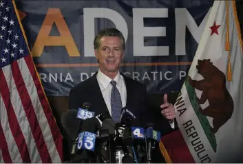  ?? RICH PEDRONCELL­I — THE ASSOCIATED PRESS ?? Gov. Gavin Newsom addresses reporters at the John L. Burton California Democratic Party headquarte­rs in Sacramento on Tuesday.