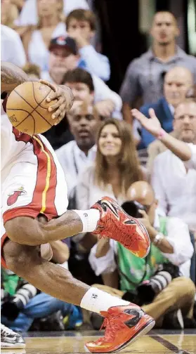  ??  ?? LEBRON JAMES inicia la marcha hacia el canasto frente a la defensa de Manu Ginóbili, de San Antonio.