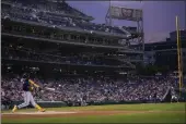  ?? ANDREW HARNIK — THE ASSOCIATED PRESS ?? The Atlanta Braves’ Ronald Acuna Jr. hits a solo home run during the first inning against the Washington Nationals at Nationals Park on Friday in Washington.