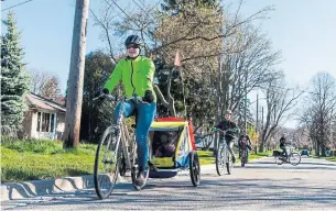  ?? NICK LACHANCE PHOTOS TORONTO STAR ?? Emily Smit runs a bike bus for kids in her Scarboroug­h neighbourh­ood. The grassroots initiative aims to provide safety in numbers and encourage students to ride.