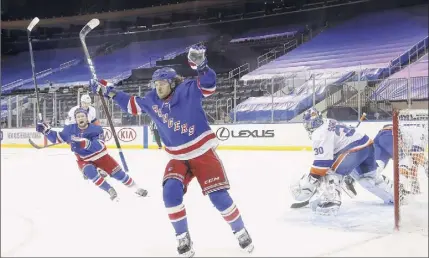  ?? Bruce Bennett / Getty Images ?? The Rangers’ Artemi Panarin celebrates in the first period after the first of his two goals against Islanders goalie Ilya Sorokin, who was making his NHL debut on Saturday. Pavel Buchnevich also scored twice for the Rangers.