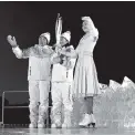  ?? THE ASSOCIATED PRESS ?? South Korean Olympic figure skating champion Yuna Kim, right, takes the torch from North Korea’s Jong Su Hyon, left, and South Korea’s Park Jong-ah during the opening ceremony of the 2018 Winter Olympics.