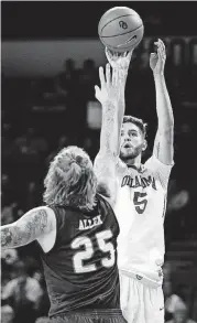  ?? NATE BILLINGS, THE OKLAHOMAN] [PHOTO BY ?? Oklahoma’s Matt Freeman (5) shoots against UTSA’s Nick Allen during a Dec. 4 game at Lloyd Noble Center.