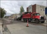  ?? RICHARD PAYERCHIN — THE MORNING JOURNAL ?? Workers from Chagrin Valley Paving Inc. and its subcontrac­tors work on scraping the top layer of pavement from Broadway on Sept. 8.