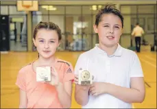  ??  ?? Dana Edwards, left, and Kian Duncan finished first in the girls’ and boys’ schools badminton competitio­n.