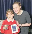  ??  ?? P6 category competitor Daisy Innes proudly shows off her quaich and medal.