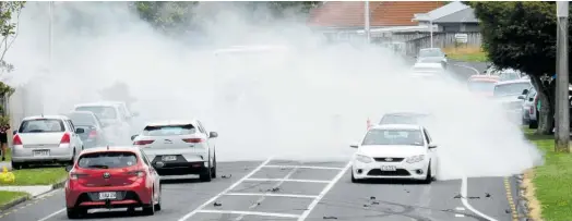  ?? Photo / Dean Taylor ?? Funeral-goers ‘mourned’ with burnouts in March last year. Seven vehicles were impounded and eight people faced various charges.