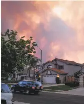  ?? Sal Guerra / Associated Press ?? Though still plagued by drought and wildfires (smoke fills the Corona sky last week), the Inland Empire is on its way back economical­ly.