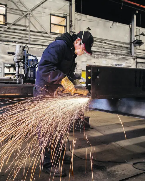  ?? DARRYL DYCK / THE CANADIAN PRESS FILES ?? NAFTA is among the main headwinds companies in Canada are facing, according to the annual survey from the Institute of Corporate Directors. Above, a worker uses a grinder on a steel girder in Burnaby, B.C.