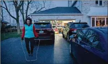  ??  ?? Olga Stavridis, 53, jump ropes in the driveway of her neighbor Donna Reda’s Upper Arlington house, while working out with personal trainer Caitlin Kennelly.