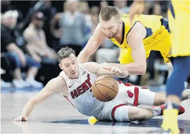  ?? MICHAEL CONROY/AP ?? Miami’s Goran Dragic and Indiana Pacers center Domantas Sabonis go to the floor for the loose ball during the first Wednesday night’s game in Indianapol­is. half of