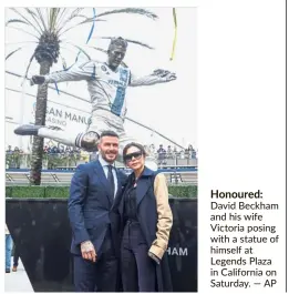  ?? — AP ?? Honoured: David Beckham and his wife Victoria posing withastatu­eof himself at Legends Plaza in California on Saturday.