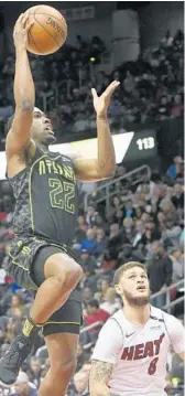  ?? JOHN AMIS/AP ?? Hawks guard Isaiah Taylor shoots as Heat guard Tyler Johnson looks for a rebound on Wednesday in Atlanta.