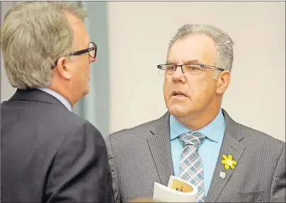  ?? MITCH MACDONALD/THE GUARDIAN ?? Opposition MLA Colin LaVie, right, speaks to Liberal MLA Doug Currie in the P.E.I. legislatur­e on Tuesday. LaVie questioned the government on the $2 million it spends annually on landlines through its contract with Bell Aliant.