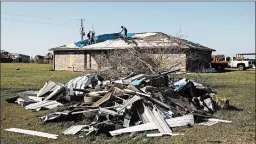  ?? WILLIAMWID­MER/THE NEW YORK TIMES ?? Austin Pearce, center, works with his uncles to replace a tarp over the weekend in Iowa, Louisiana. The tarp was initially installed on his roof after Hurricane Laura hit Aug. 27.