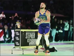  ?? STACY REVERE — GETTY IMAGES ?? Warriors star Stephen Curry edged WNBA star Sabrina Ionescu in a battle of the sexes 3-point shootout during the NBA's All-Star Saturday Night.