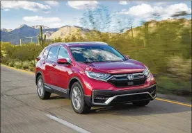  ?? AMERICAN HONDA MOTOR CO. VIA AP ?? This photo provided by Honda shows a 2021 Honda CR-V Hybrid, an all-wheel-drive hybrid crossover SUV.