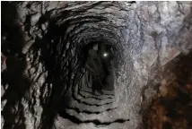  ?? (Khalil Ashawi/Reuters) ?? REBEL FIGHTERS inspect a tunnel, which they said belonged to Islamic State fighters and connects the northern Syrian city of al-Bab to Aqeel Mountain, earlier this month.