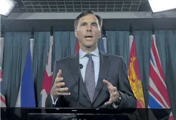  ?? ADRIAN WYLD/THE CANADIAN PRESS ?? Finance Minister Bill Morneau speaks with reporters Thursday on Parliament Hill.