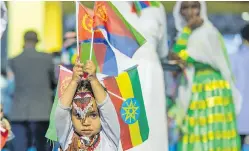  ?? THE ASSOCIATED PRESS ?? A child holds Ethiopian and Eritrean flags in the Ethiopian capital, Addis Ababa, during peace celebratio­ns this month.