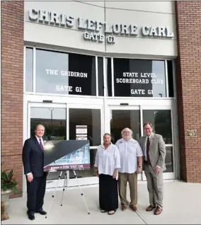  ?? ?? MSU President Mark E. Keenum, left, and Athletics Director John Cohen, right, stand with Margaret and Fred Carl Jr. under the Davis Wade Stadium gate that now bears the name of the Carls’ late son, Chris. (Photo by Megan Bean, MSU)