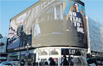  ??  ?? Licence revoked: an advertisem­ent for No Time to Die, the new James Bond film, at Piccadilly Circus, London, in December last year