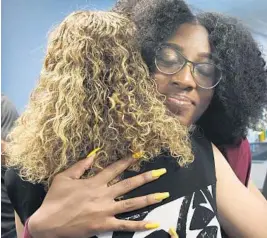  ?? TAIMY ALVAREZ/STAFF PHOTOGRAPH­ER ?? U.S. Rep. Debbie Wasserman Schultz hugs Stoneman Douglas High School junior Tyah Amoy-Roberts after the news conference in Pembroke Pines.